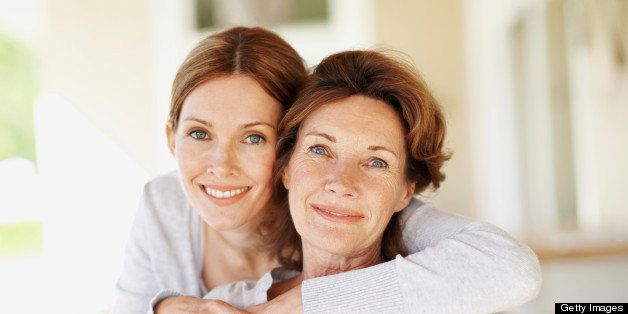 Smiling mother with her happy adult daughter - portrait