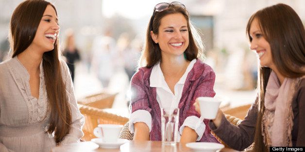 Three young women drinking coffee in a cafe.