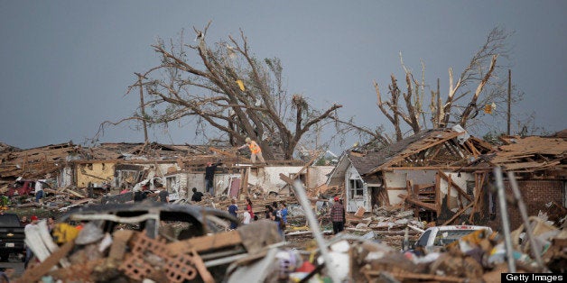 MOORE, OK - MAY 20: People assess the damage after a powerful tornado ripped through the area on May 20, 2013 in Moore, Okla