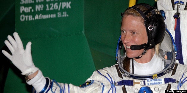 US astronaut Karen Nyberg waves as she board the Soyuz TMA-09M spacecraft at the Russian-leased Baikonur cosmodrome on May 29, 2013. The crew with US astronaut Karen Nyberg, Russian cosmonaut Fyodor Yurchikhin and European Space Agency (ESA) Italian astronaut Luca Parmitano blast off early on May 29 for the International Space Station (ISS) aboard a Soyuz TMA-09M spacecraft. AFP PHOTO/POOL/KIRILL KUDRYAVTSEV (Photo credit should read KIRILL KUDRYAVTSEV/AFP/Getty Images)