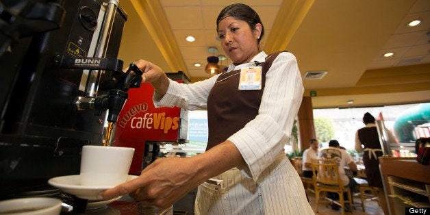 Waitress Clara Beltran pours coffee at a Vips restaurant in the El Toreo neighborhood of Mexico City, Mexico, on Monday, June 17, 2013. Wal-Mart de Mexico SAB de CV, known as Walmex, is considering offers to sell its restaurant division, which includes the Vips, El Porton, Ragazzi and La Finca brands. Photographer: Susana Gonzalez/Bloomberg via Getty Images
