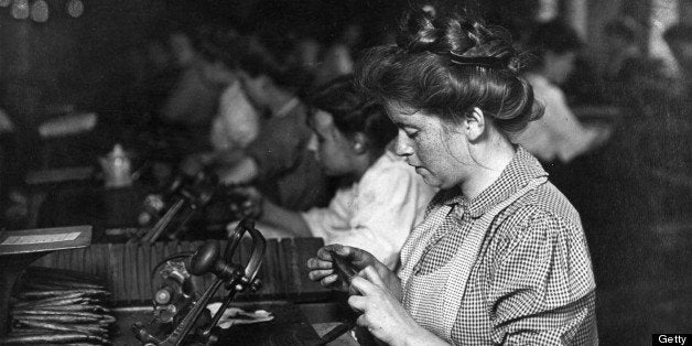 circa 1909: A young woman with freckles on her face works at her station in a cigar factory, Pittsburgh, Pennsylvania. (Photo by Lewis W. Hine/George Eastman House/Getty Images)