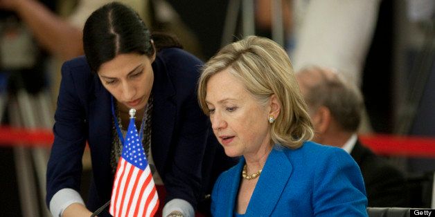 Hillary Clinton, U.S. secretary of state, reads documents with Deputy Chief of Staff Huma Abedin prior to a bilateral talk at the 43rd Association of Southeast Asian Nations (ASEAN) Ministerial and related meetings on Thursday, July 22, 2010. The U.S. said it will intensify sanctions against North Korea for sinking a South Korean warship, targeting members of Kim Jong Il's regime and the foreign banks that help sustain the country's weapon's industy. Photographer: Nelson Ching/Bloomberg via Getty Images