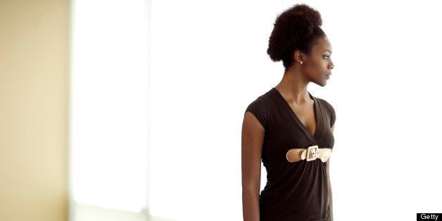 A businesswoman looking out the window of a conference room...