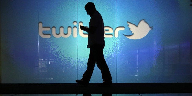A user checks a Twitter feed on a smartphone in this arranged photograph taken in London, U.K., on Friday, Oct. 4, 2013. Twit