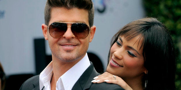 Robin Thicke and his wife Paula Patton arrive at the BET Awards at the Nokia Theatre on Sunday, June 30, 2013, in Los Angeles. (Photo by Chris Pizzello/Invision/AP)