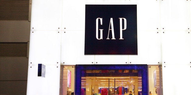 A man walks past a Gap Inc. store in the Wangfujing shopping district of Beijing, China, on Sunday, March 10, 2013. China?s industrial output had the weakest start to a year since 2009 and lending and retail sales growth slowed, toughening challenges for a new leadership that wants to narrow the gap between rich and poor. Photographer: Tomohiro Ohsumi/Bloomberg via Getty Images