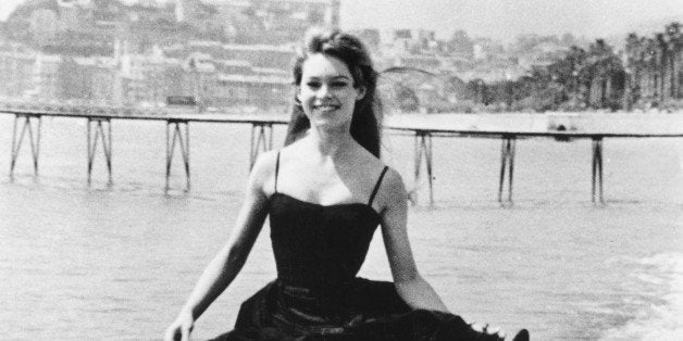 FRANCE - APRIL 01: The French Star Brigitte Bardot Strolling On The Beach Of Cannes During The Cannes Film Festival, On Apri