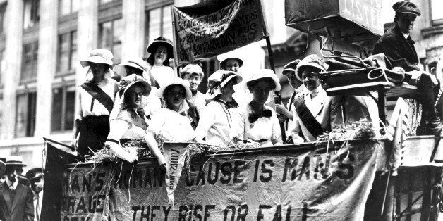 View of women riding in a Hay Wagon float in a suffrage parade to New York's City Hall, 1913. A banner hanging upon the float quotes Tennyson's phrase 'The Woman's Cause Is Man's; They Rise Or Fall Together'. (Photo by PhotoQuest/Getty Images)