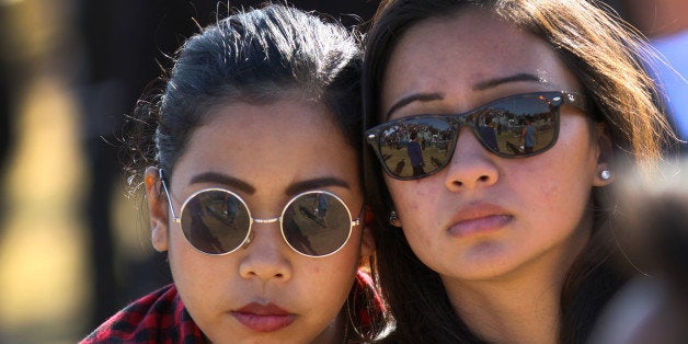 ISLA VISTA, CA - MAY 27: Students mourn at a public memorial service on the Day of Mourning and Reflection for the victims of a killing spree at University of California, Santa Barbara on May 27, 2014 in Isla Vista, California. Elliot Rodger killed six college students at the start of Memorial Day weekend and wounded seven other people, stabbing three then shooting and running people down in his BMW near UCSB before shooting himself in the head as he drove. Police officers found three legally-purchased guns registered to him inside the vehicle. Prior to the murders, Rodger posted YouTube videos declaring his intention to annihilate the girls who rejected him sexually and others in retaliation for his remaining a virgin at age 22. (Photo by David McNew/Getty Images)