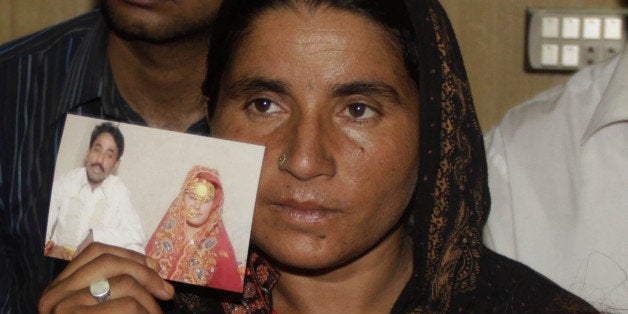 LAHORE, PAKISTAN - MAY 31: Pakistani Khalida Parveen, sister of Farzana Parveen, punished with stone to death by her father and other family members for marrying a man of her own choice, shows the picture of her sister during a press conference in Lahore, Pakistan on May 31, 2014. A Pakistani court extended the detention period of the father, for extra time to investigate the crime, police said. Farzana Parveen died after the attack, with stones and bricks, of more than two dozen people including relatives, outside Lahore's High Court on May 27 for marrying against her family's wishes. (Photo by Rana Irfan Ali/Anadolu Agency/Getty Images)