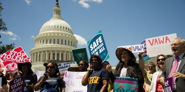 Supporters of the National Organization for Women (NOW) and the National Task Force to End Sexual Assault and Domestic Violence Against Women hold a rally for the reauthorization of the Violence Against women Act (VAWA) outside the US Capitol in Washington on June 26, 2012. AFP PHOTO/Jim Watson (Photo credit should read JIM WATSON/AFP/GettyImages)