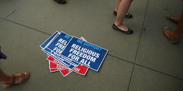 WASHINGTON, DC - JUNE 30: Signs lie on the ground during a protest in front of the U.S. Supreme Court June 30, 2014 in Washington, DC. The high court is expected to hand down its ruling on whether a private company can, on religious grounds, be exempted from health care reform's requirement that employer sponsored health insurance policies cover contraception. (Photo by Mark Wilson/Getty Images)