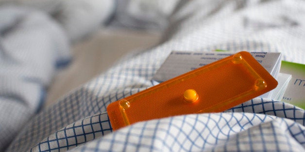 BONN, GERMANY - NOVEMBER 28: A abortion pill 'PiDaNa from HRA Pharma' in a rumpled bed on November 28, 2013 in Bonn, Germany.