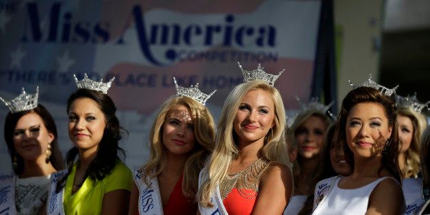 Miss America Pageant contestants, from left, Miss Idaho Sierra Sandison, Miss Hawaii Stephanie Steuri, Miss Georgia Maggie Bridges, Miss Florida Victoria Cowan, and Miss District of Columbia Teresa Davis watch arrival ceremonies Wednesday, Sept. 3, 2014, in Atlantic City, N.J. Miss America contestants from all 50 states, the District of Columbia, Puerto Rico and the U.S. Virgin Islands will appear Wednesday afternoon at the traditional welcoming ceremony across from Boardwalk Hall. (AP Photo/Mel Evans)