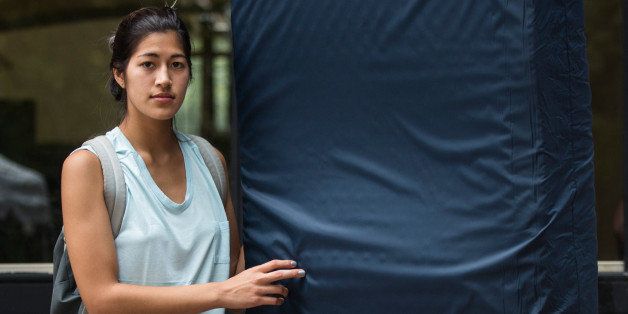 NEW YORK, NY - SEPTEMBER 05: Emma Sulkowicz, a senior visual arts student at Columbia University, poses with a mattress, which she says she will carry every where she goes in protest of the university's lack of action after she reported being raped during her sophomore year, on September 5, 2014 in New York City. Sulkowicz has said she is committed to carrying the mattress everywhere she goes until the university expels the rapist or he leaves. The protest is also doubling as her senior thesis project. (Photo by Andrew Burton/Getty Images)