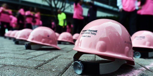 Pink hard hats are seen laying on the ground before participants form a human pink ribbon in New York on October 7, 2014, as part of Protect Yourself, Get Screened Today campaign to raise awareness for the millions of lives affected by breast cancer and encouraging women to get screened. AFP PHOTO/Jewel Samad (Photo credit should read JEWEL SAMAD/AFP/Getty Images)