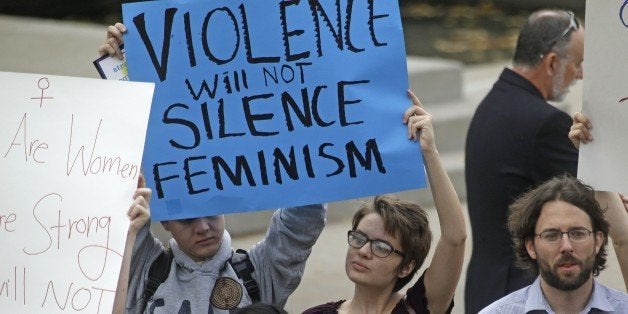 People protest on the campus of Utah State, Wednesday, Oct. 15, 2014, in Logan, Utah. Utah's campus gun laws are in the spotlight after a feminist speaker canceled a speech at Utah State University once she learned the school would allow concealed firearms despite an anonymous threat against her. School officials in Logan were set to go ahead with the event with extra police after consulting with federal and state law enforcement who told them the threat was consistent with ones Anita Sarkeesian receives when she gives speeches elsewhere. (AP Photo/Rick Bowmer)