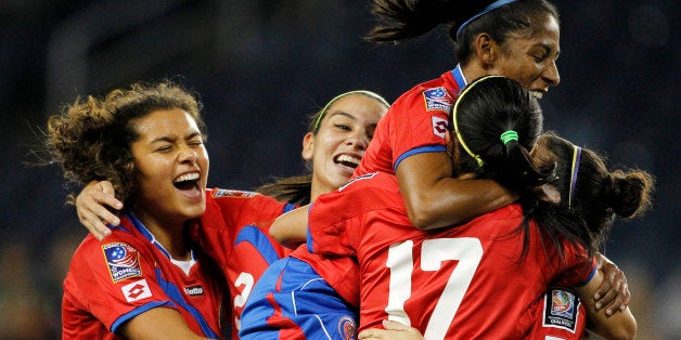 From left to right, Costa Rica's Raquel Rodriguez, Wendy Acosta, Diana Saenz, and Melissa Herrera (17) congratulate Carolina Venegas, right, after she scored a goal against Mexico during the first half of a CONCACAF Women's Championship soccer match, Thursday, Oct. 16, 2014, in Kansas City, Kan. (AP Photo/Colin E. Braley)