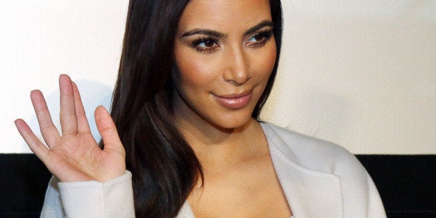 Television personality Kim Kardashian waves prior to a news conference in Vienna, Austria, Thursday, Feb. 27, 2014. Kardashian will be Austrian businessman Richard Lugner's special guest at this year's Opera Ball. (AP Photo/Ronald Zak)