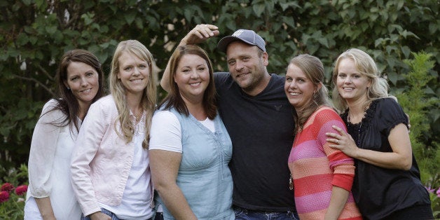 FILE - In this Sept. 11, 2013, file photo, Brady Williams poses with his wives, from left to right, Paulie, Robyn, Rosemary, Nonie, and Rhonda, outside of their home in a polygamous community outside Salt Lake City. The newest polygamous family from Utah on reality TV says sharing their story with a wide audience has been liberating. The first of nine episodes chronicling the life of Williams, his five wives and their 24 children airs Sunday on TLC. A pilot episode aired last fall of the show, being called "My Five Wives." Williams and his wives said in an interview with The Associated Press that they enjoy being able live openly and not worry about who knows about their lifestyle. (AP Photo/Rick Bowmer, File)