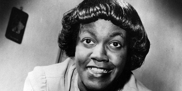 American writer Gwendolyn Brooks, of Chicago, Ill., poses with her first book of poems titled "A Street in Bronzeville," 1945