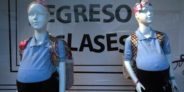 Mannequins of pregnant girls are displayed at a mall's window shop to increase public awareness of early pregnancy, in Caraca