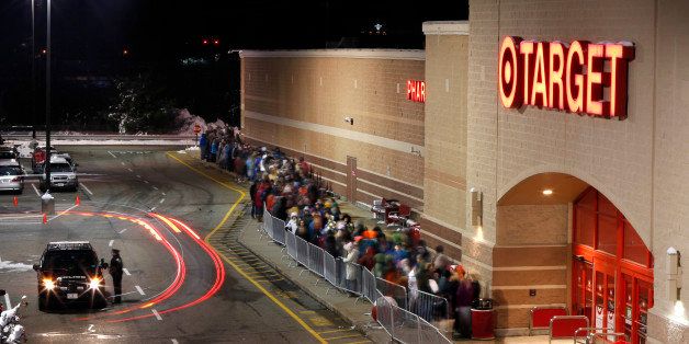 Shoppers head into Target just after their doors opened at midnight on Black Friday, Nov. 28, 2014, in South Portland, Maine. (AP Photo/Robert F. Bukaty)