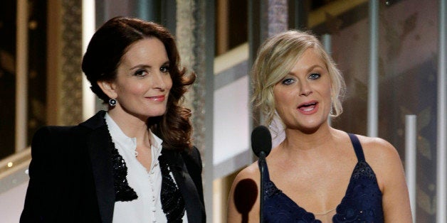 BEVERLY HILLS, CA - JANUARY 11: In this handout photo provided by NBCUniversal, Hosts Tina Fey and Amy Poehler speak onstage during the 72nd Annual Golden Globe Awards at The Beverly Hilton Hotel on January 11, 2015 in Beverly Hills, California. (Photo by Paul Drinkwater/NBCUniversal via Getty Images)