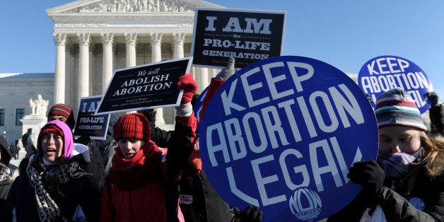 Pro-abortion and anti-abortion protestors rally outside the Supreme Court in Washington, Wednesday, Jan. 22, 2014. Thousands