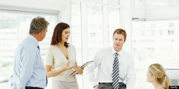 Two businessmen and two businesswomen having discussion in office