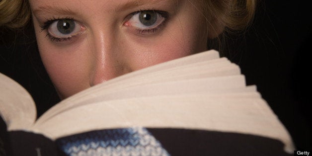 LONDON, ENGLAND - SEPTEMBER 15: A model reads Fifty Shades of Grey backstage ahead of the Jasper Conran show on day 2 of Lond
