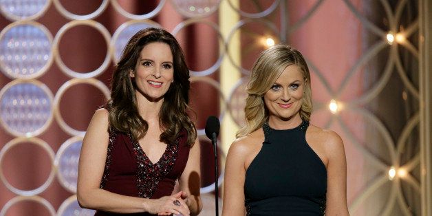 This image released by NBC shows hosts Tina Fey, left, and Amy Poehler during the 71st annual Golden Globe Awards at the Beverly Hilton Hotel on Sunday, Jan. 12, 2014, in Beverly Hills, Calif. (AP Photo/NBC, Paul Drinkwater)