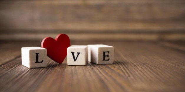 Love message written in wooden blocks. Red heart.