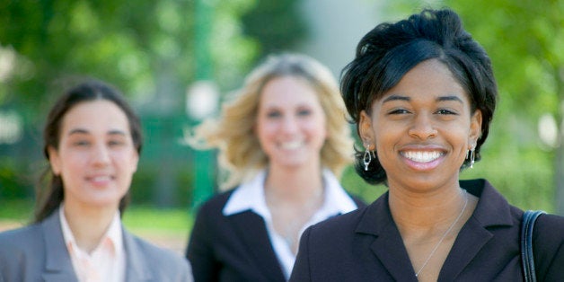 Three businesswomen smiling