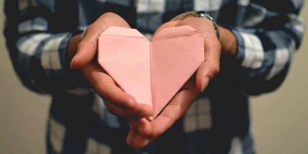 Close-Up Of Man Holding Paper Heart