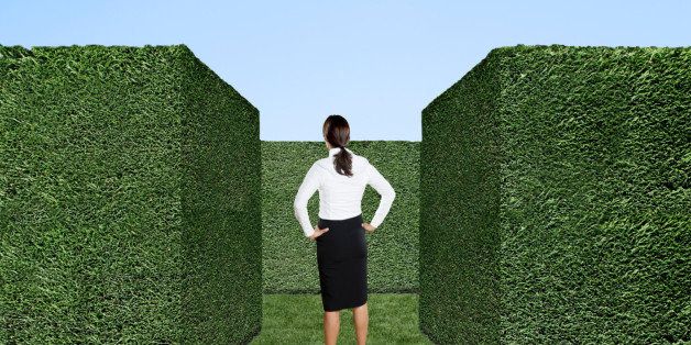 Businesswoman standing at entrance of labyrinth