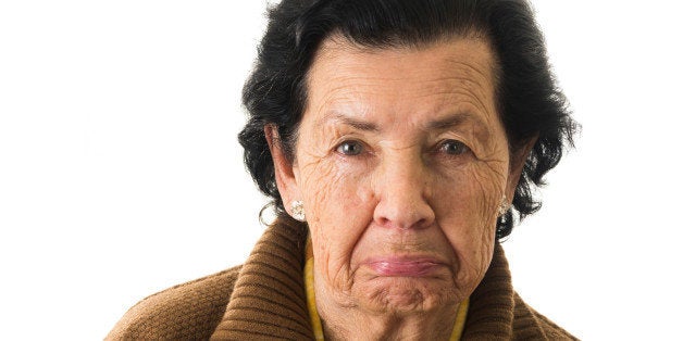 closeup portrait of old cranky grumpy sad woman grandmother