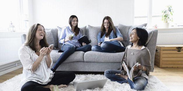 Female friends spending leisure time together in living room