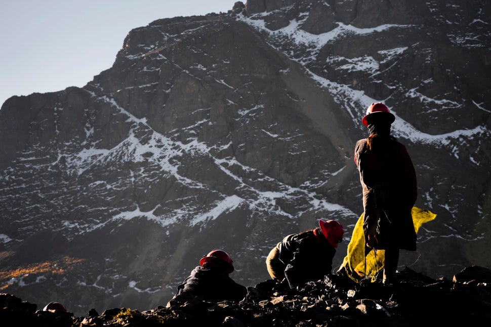 Pallaqueras, female gold miners, search for gold on a load of waste rock from the gold mines on Aug. 4 2012 in La Rinconada, 