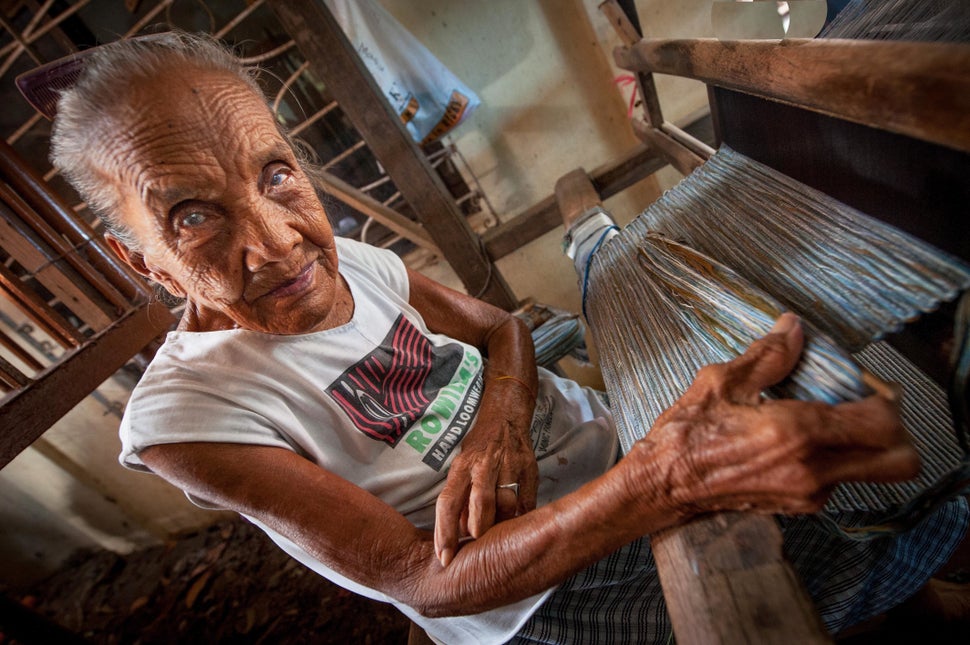 A woman working on her wooden weaving loom in the countryside of Bhutan. (Andrew Eio/Getty Images)
