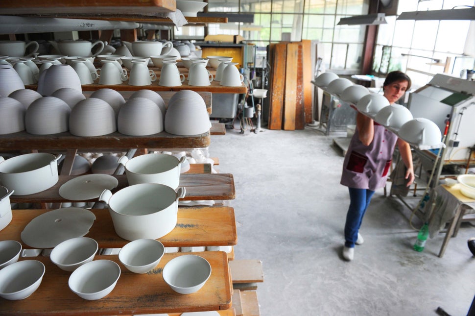 A woman works at a plant of porcelain manufacturing society JL Coquet in Saint-Leonard-de-Noblat near Limoges, France on July