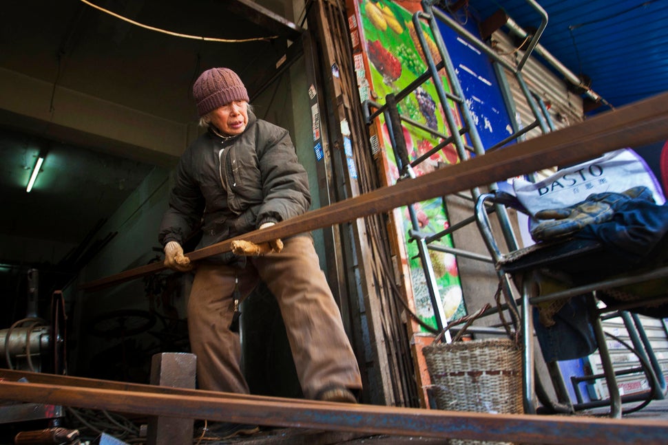 Liu Shujian, a 90-year-old lady, continues her electro welding work at Wanshousi Street on Dec. 5, 2014 in Shenyang, Liaoning