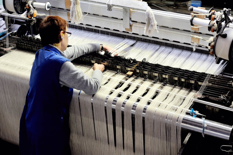 An employee of the Lemaitre Demeestere company works with a linen loom on April 16, 2013 in Halluin, northern France. (PHILIP