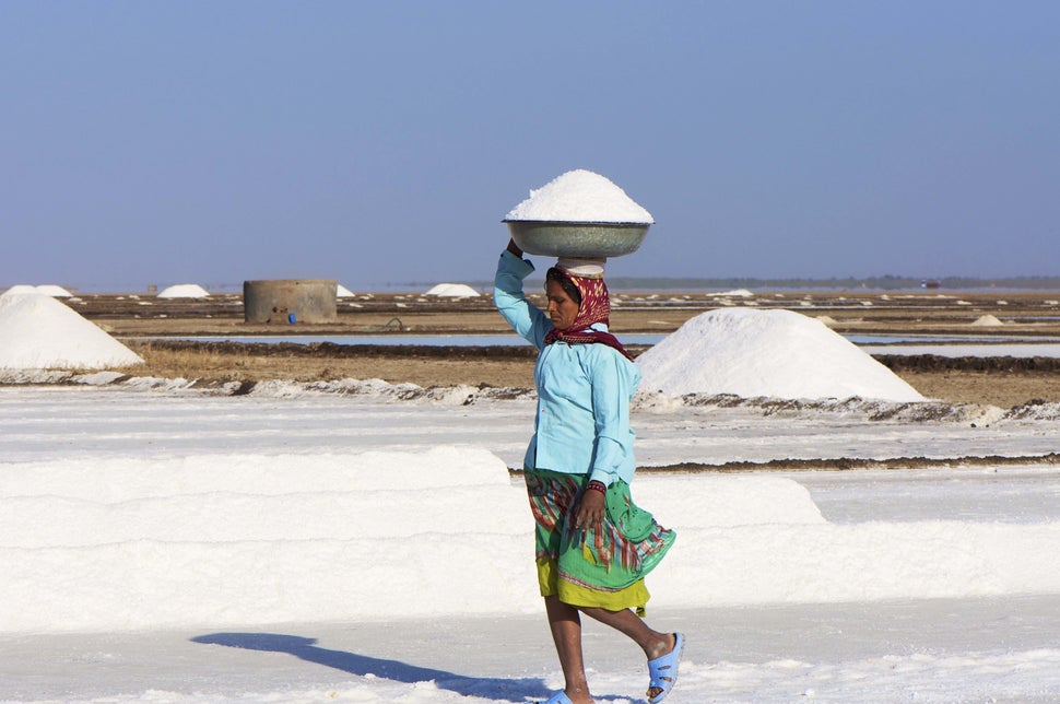 An Indian woman works collecting salt in the salt pans near Dhrangadhra, Gujarat.  (Malcolm Chapman/Getty Images)
