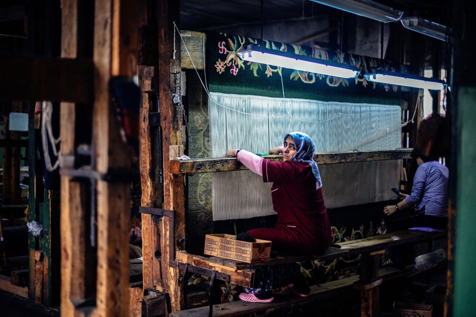 Photo taken on January 22, 2014, shows women working on a carpet in a tiny factory in Kostandovo, a small village in Bulgaria