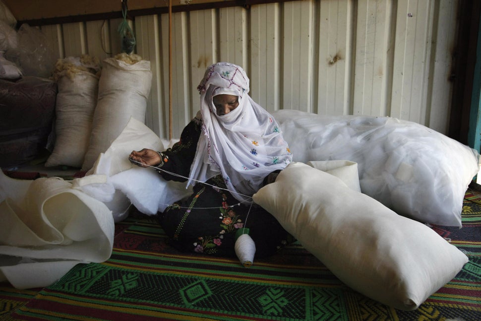 Bedouin shop owner, Farawna Nasra Abu Adjin, 50, fashions a pillow by hand in her workshop started with a micro-finance loan 