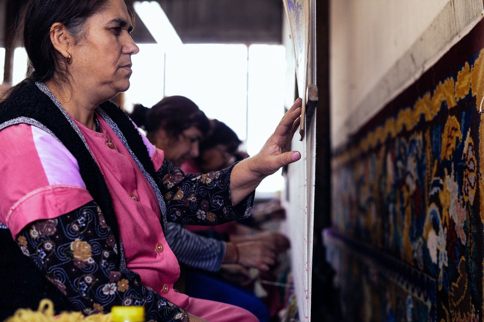 This picture taken on January 22, 2014 shows women working on a carpet in a tiny factory in Kostandovo, a small village in Bu