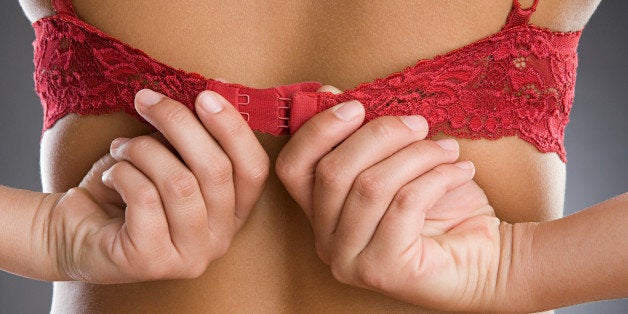 Woman putting on brassiere