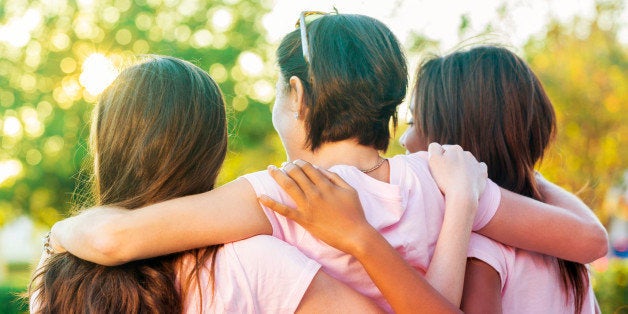 Women embracing after finishing breast cancer awareness race